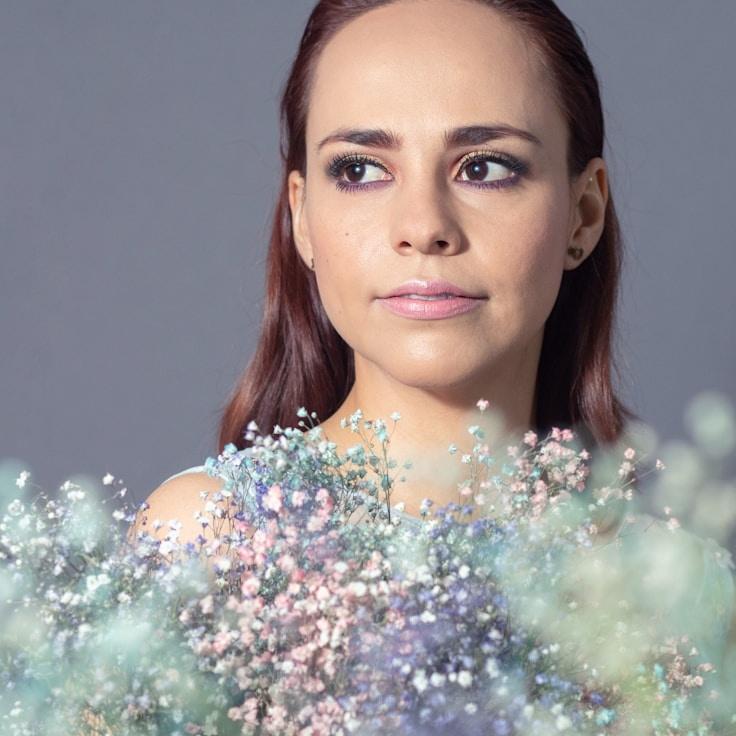 Avery Chen, Lead Design Curator at DuskPetalGrove, reviewing corporate floral arrangements